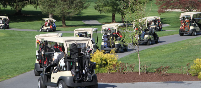 Image: Golf carts driving to hole at beginning of tournament Image: Golf carts driving to hole at beginning of tournament